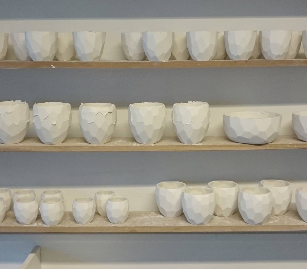 Poligon cups waiting to be colored and glazed