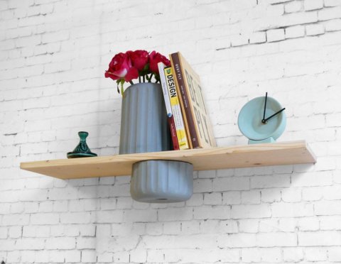The vase-shelf. A wall mount shelf with a vase cut in half. The bottom part functions as a drawer