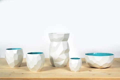 Our classic: The Poligon tableware, with an emerald green inside and white outside
