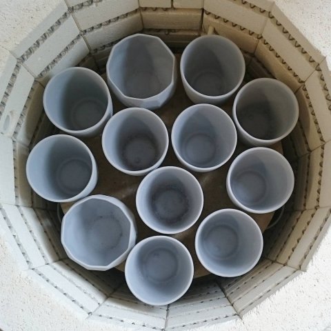 Every day firing the kiln 🔥. these grey cups will result in full back cups