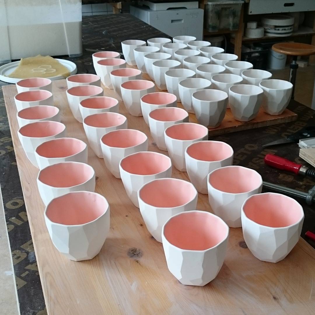 Glazing the poligon cups before these go into the kiln on 1240 degrees