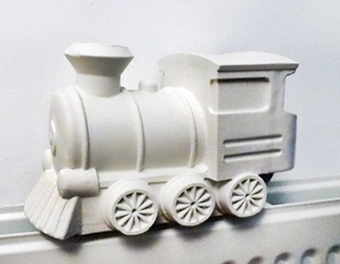 Fill this porcelain train with water and put it on your heater, so it becomes a steamtrain humidifier